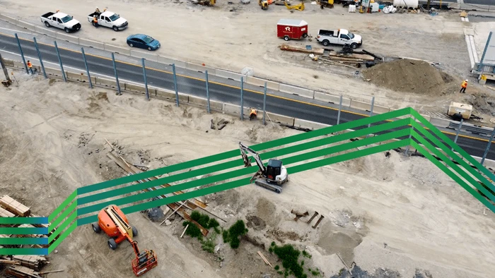 Birds eye view of construction site with new noise barrer wall