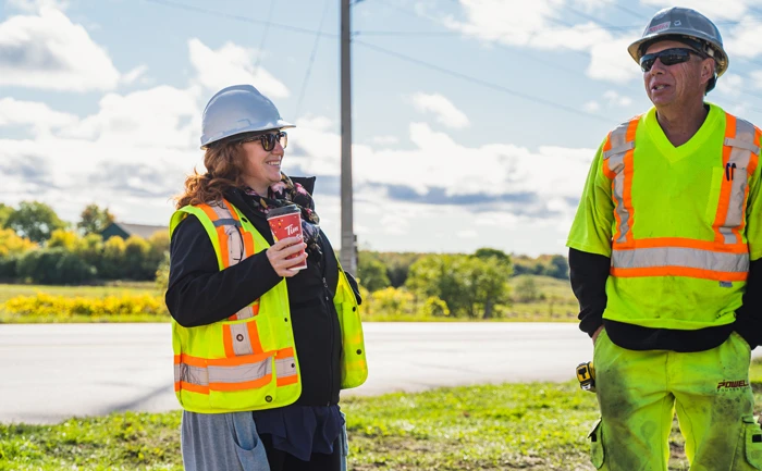 man and woman in hard hat smiling standing together